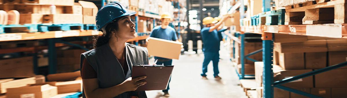 A female businesswoman review supply logs in a warehouse